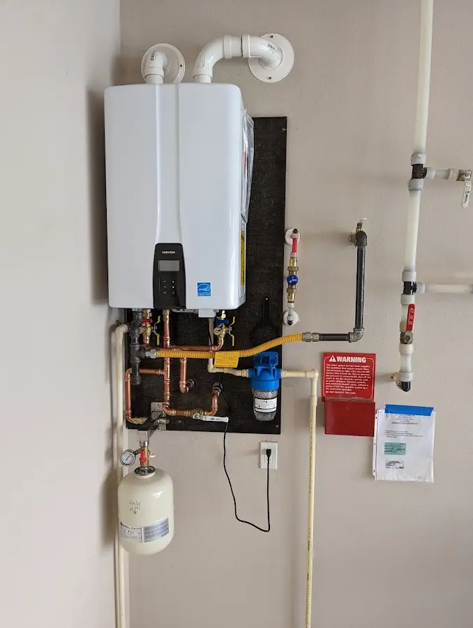 Professional plumber installing copper piping in a McLoud home